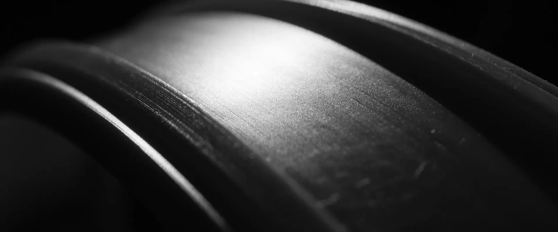 Close-up of a weight plate edge in dramatic light