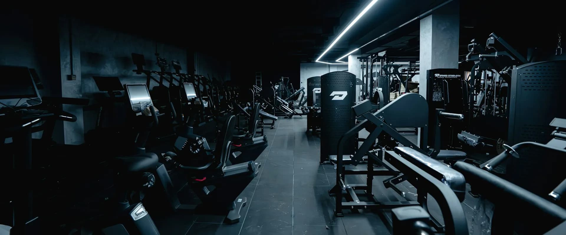 Wide view of a dark gym with training equipment