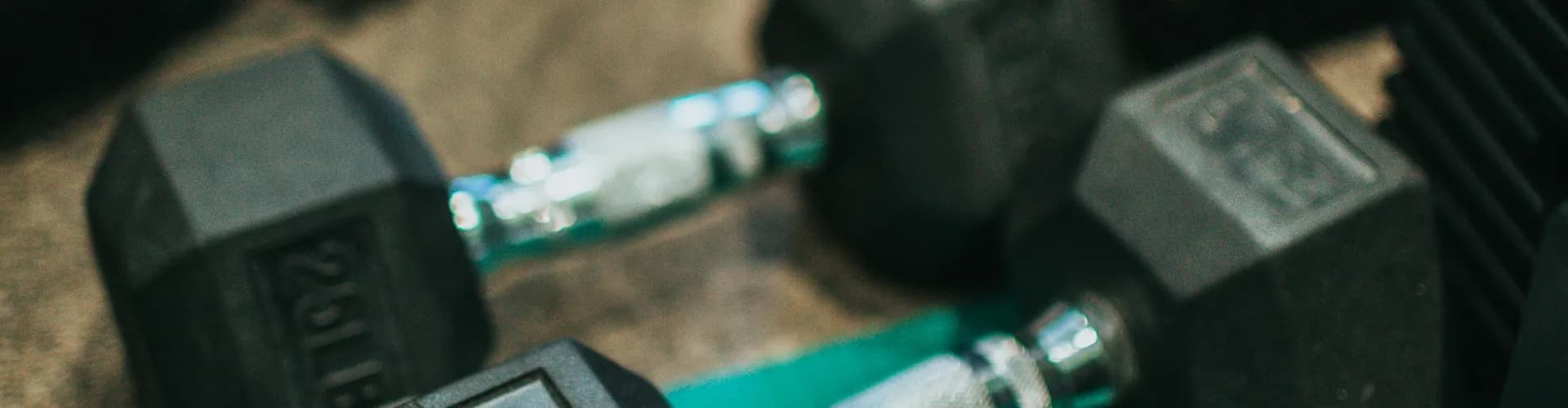 Two dumbbells on a gym floor
